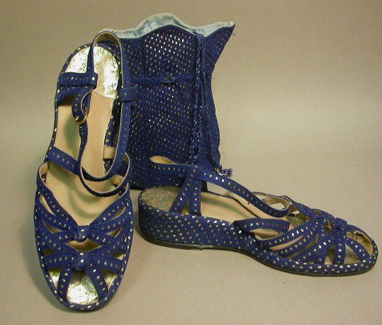 Blue strappy sandals with silver stud design and a matching bag.