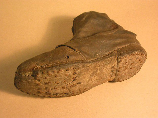 Sole of the boot shows worn hobnails on the heel and ball area.