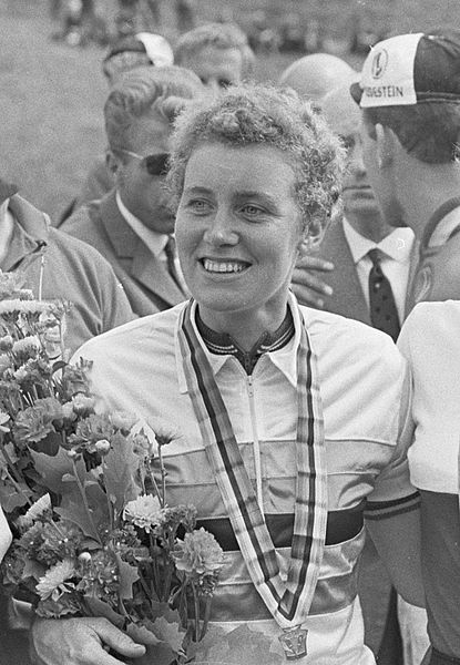 Black and white photograph showing Beryl  with a medal and flowers