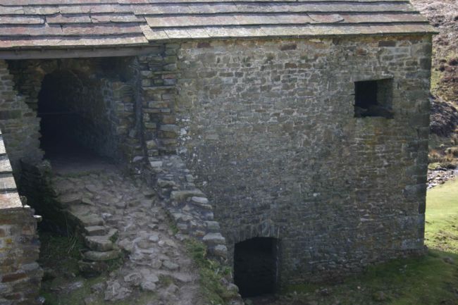 Stone building showing collapsed arched tunnel