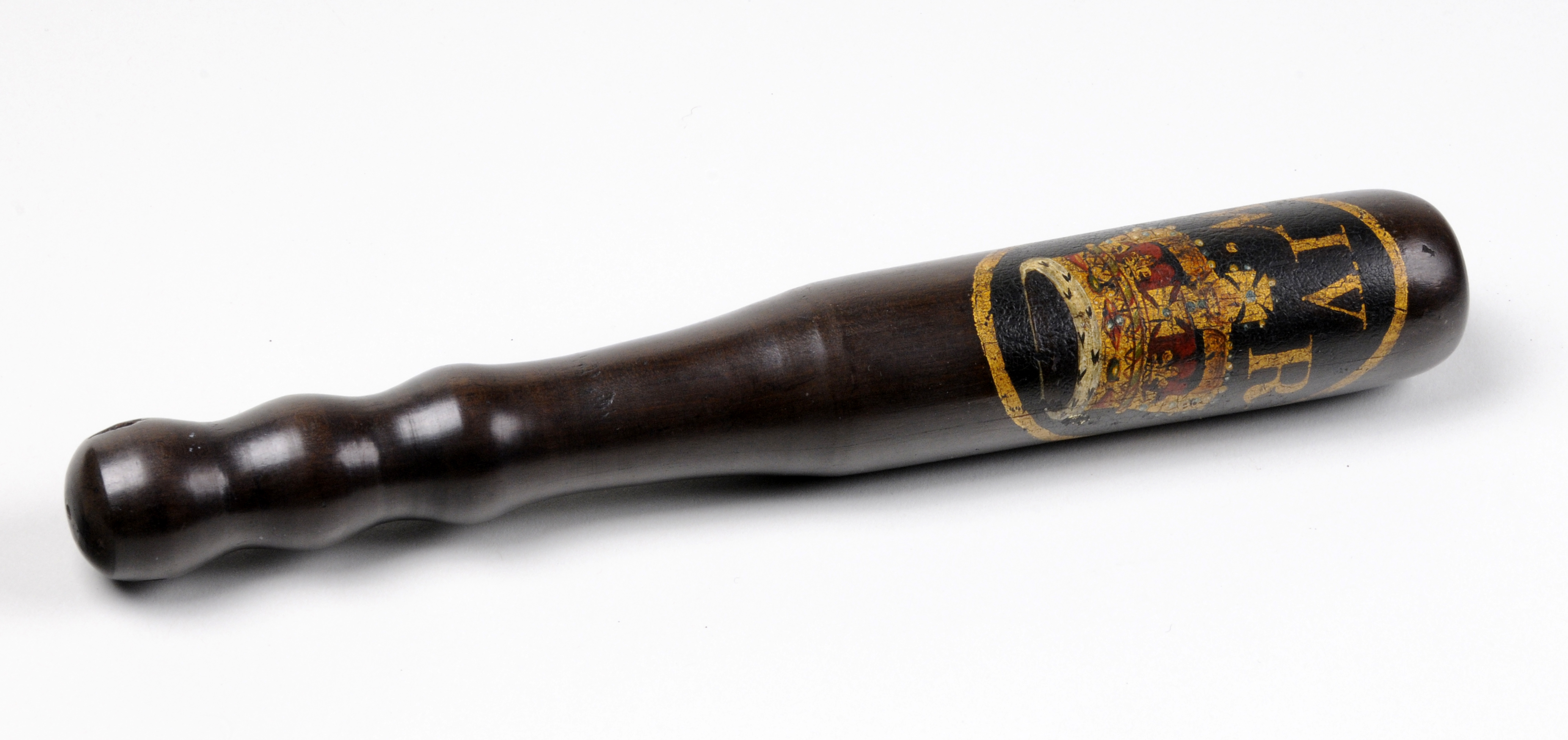 The truncheon is made of dark brown wood. Then handle is carved so that it can be easily gripped. On the baton end is painted a crown in gold, red and white paint, with the letters WIVR in gold paint.