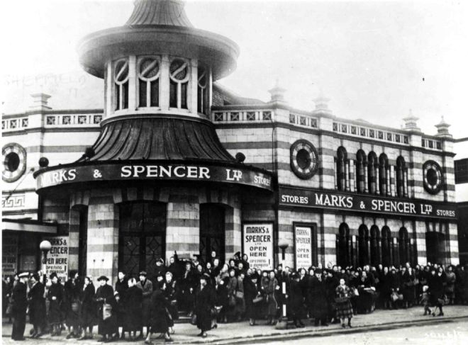 Black and white image of a striking building with Marks and Spencer Ltd around the outside.
