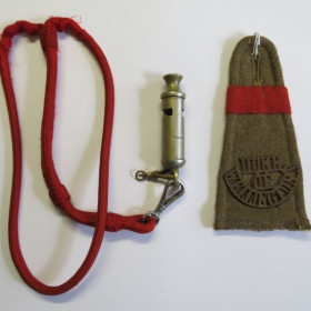 Metal army service whistle with red ribbon and embroidered epaulette