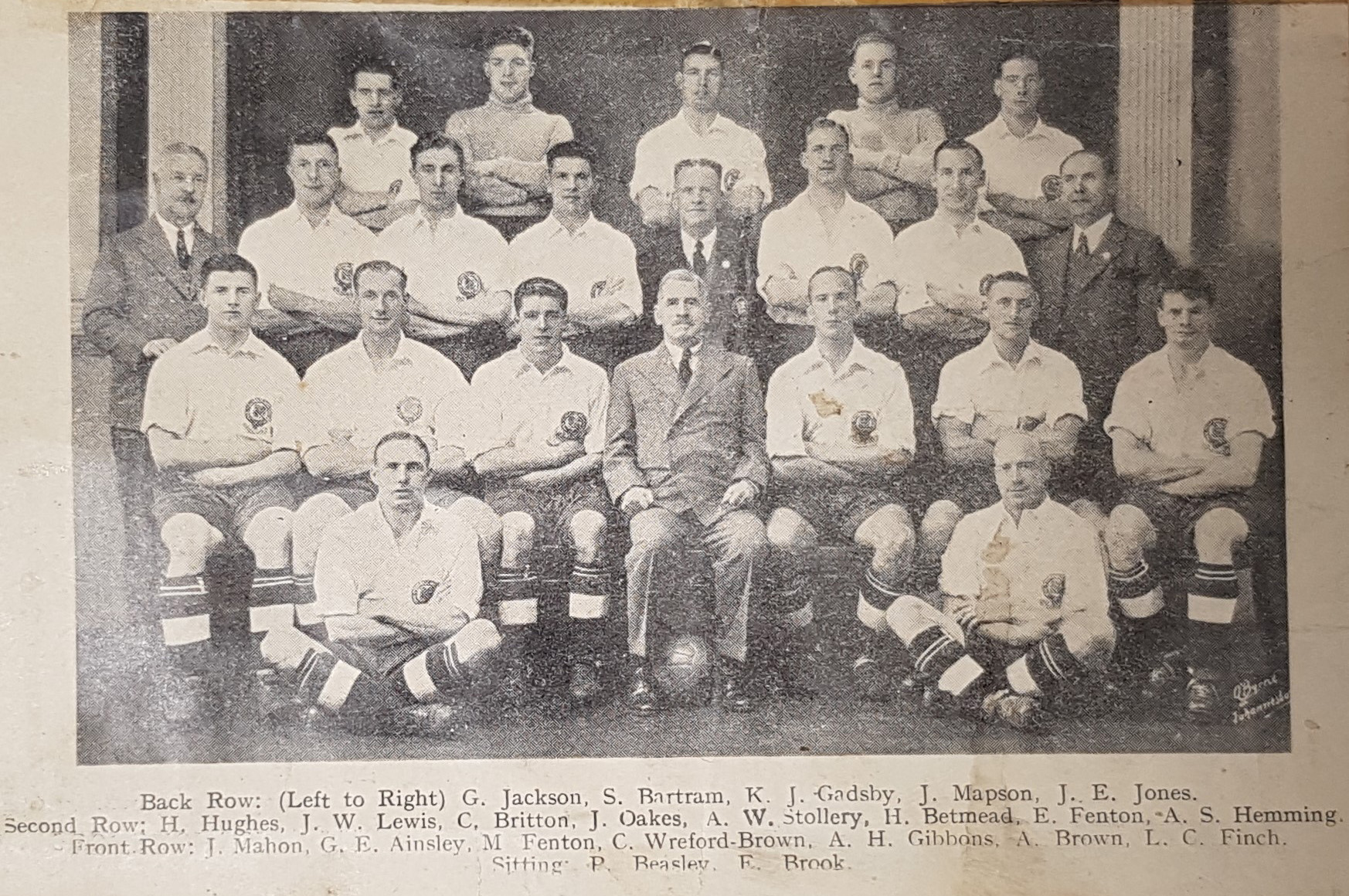 Black and white photograph of the football squad sitting for a formal photograph
