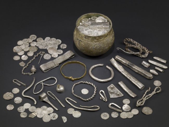 A large hoard of silver items, including coins, bracelets, a silver pot, other items of jewellery and silver ingots.