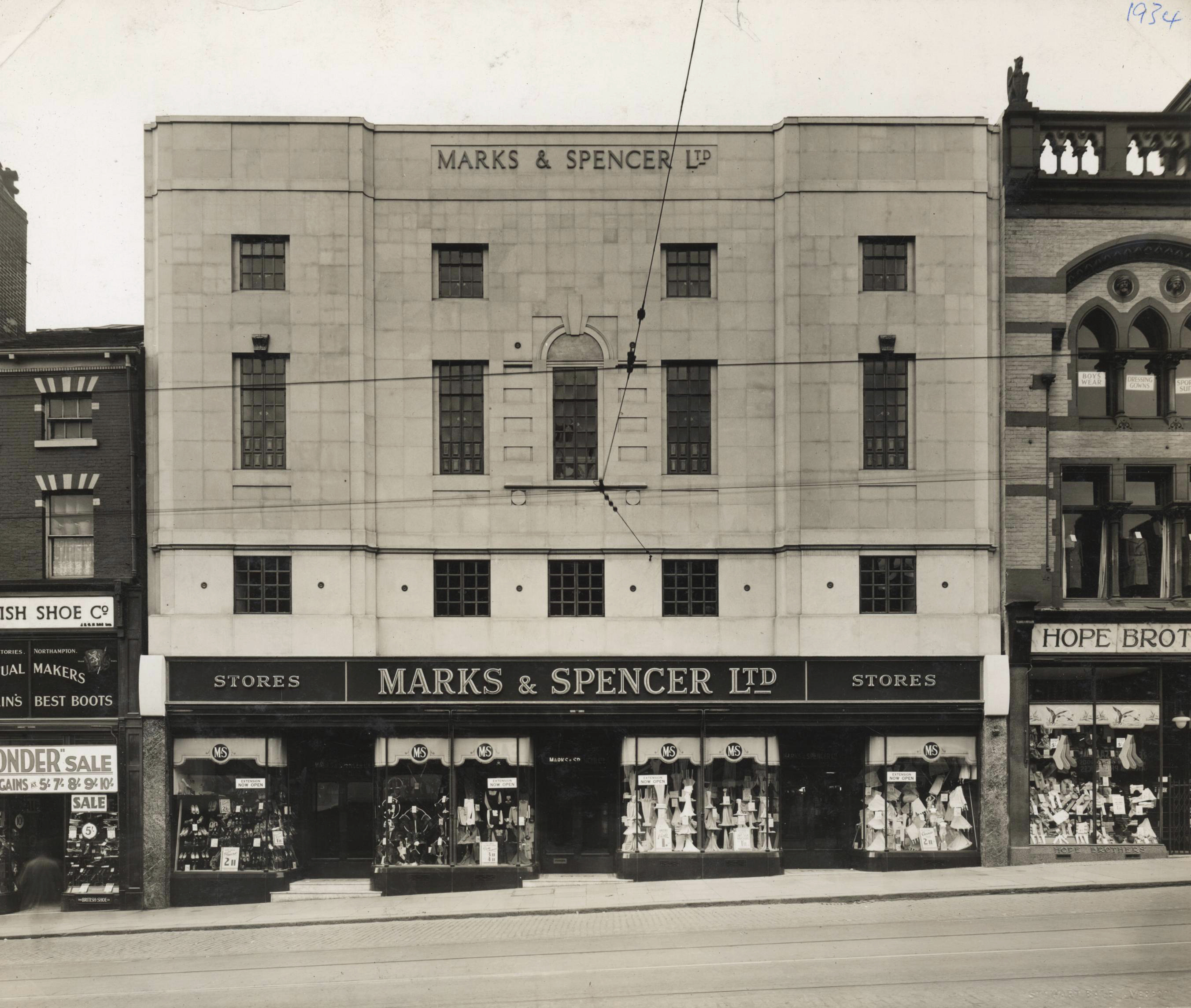 Black and white photo of 3-storey department store with signage 'Marks & Spencer Ltd' above shop frontage