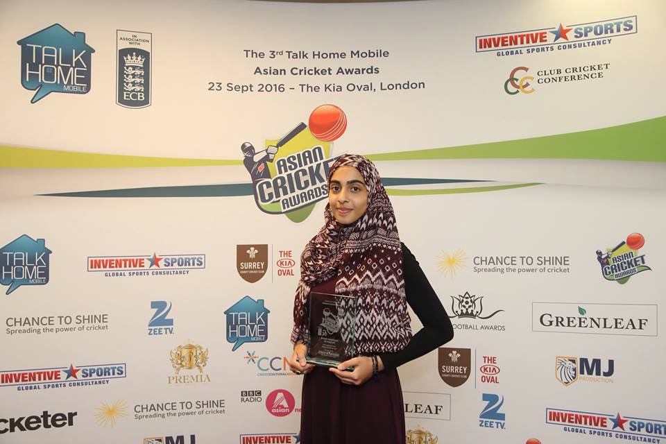 Photograph of Maryam holding a trophy
