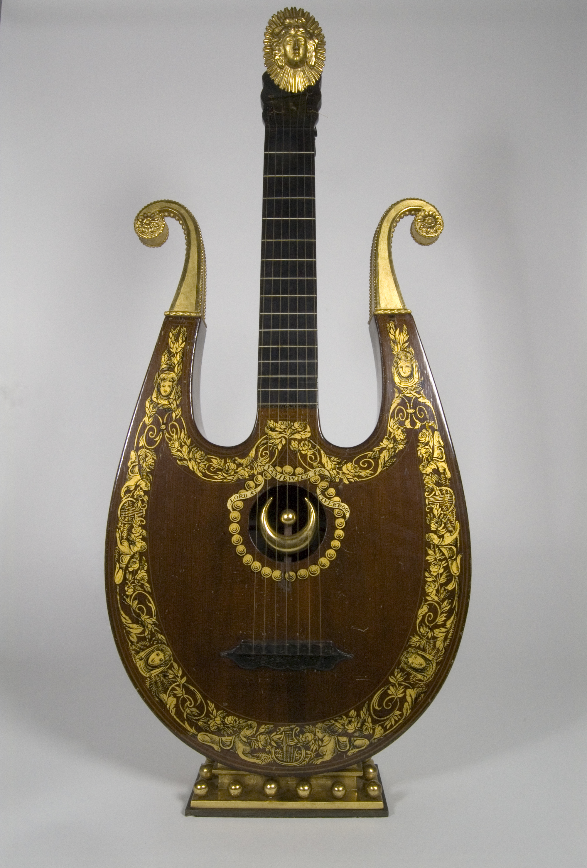 Colour photograph showing a lyre - a  stringed instrument with beautiful gilded decoration