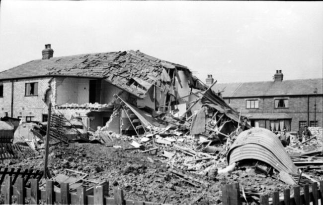 Bombed air raid shelter in Kathleen Road, Hull. Some of a row of terraced houses have been destroyed and the air raid shelter is also damaged.