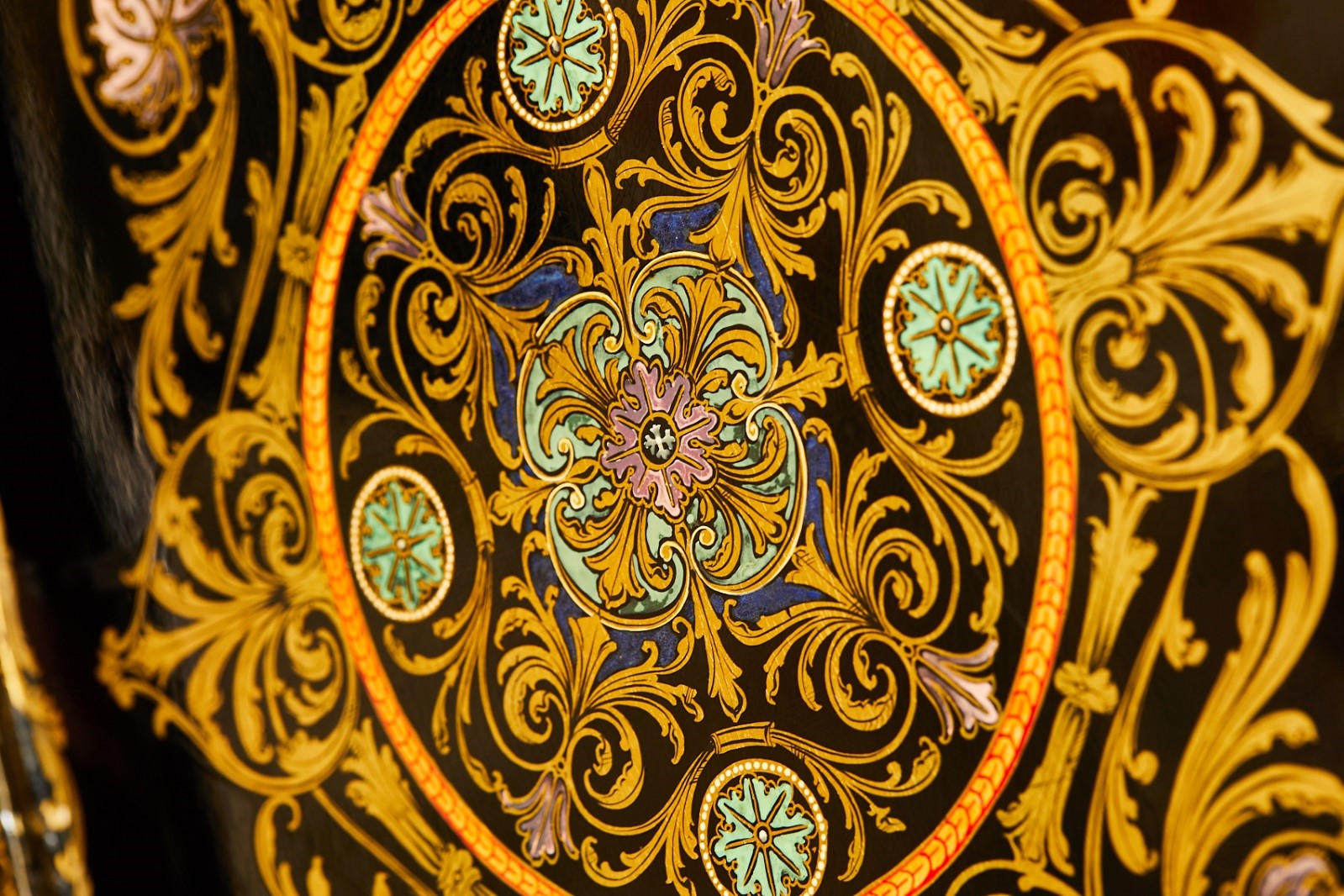 Inlaid detailed design of leaf motifs and swirls in yellow, blue and pink