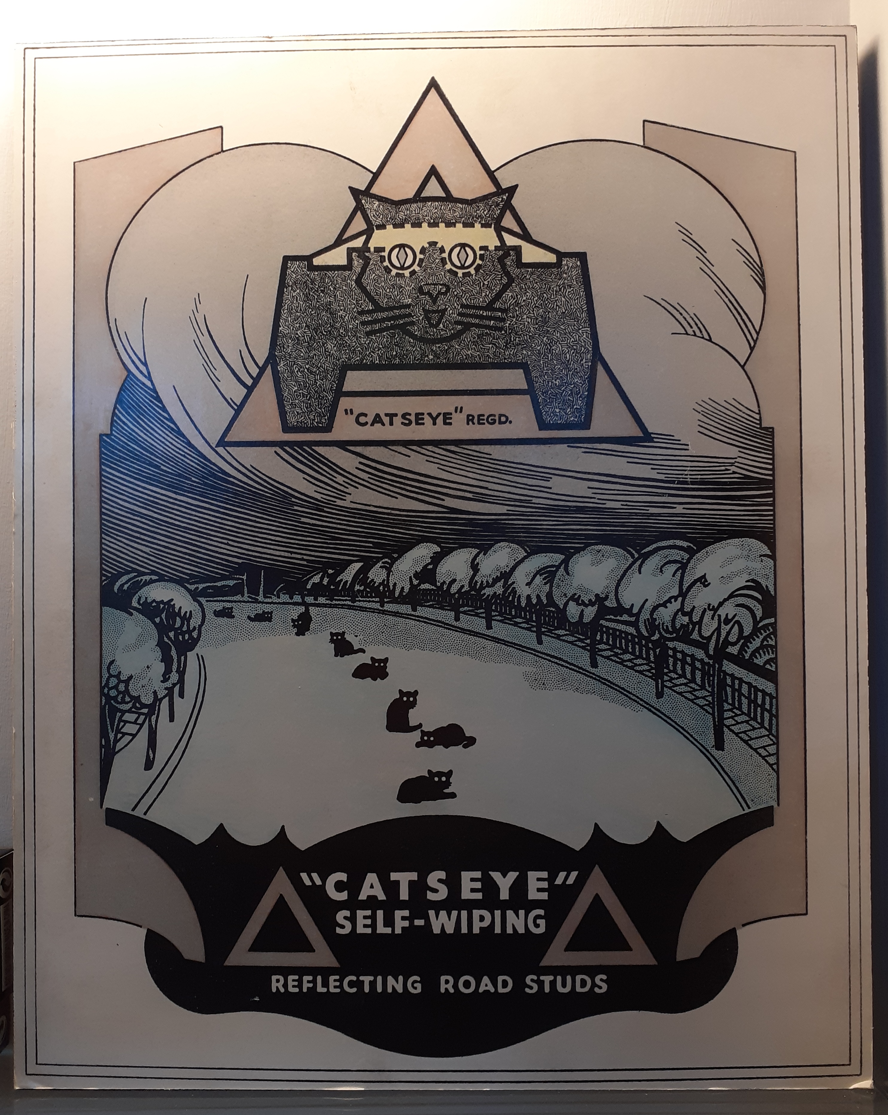A poster showing a series of black cats sitting down the middle of a road with the text 'catseye self-wiping reflecting road studs'