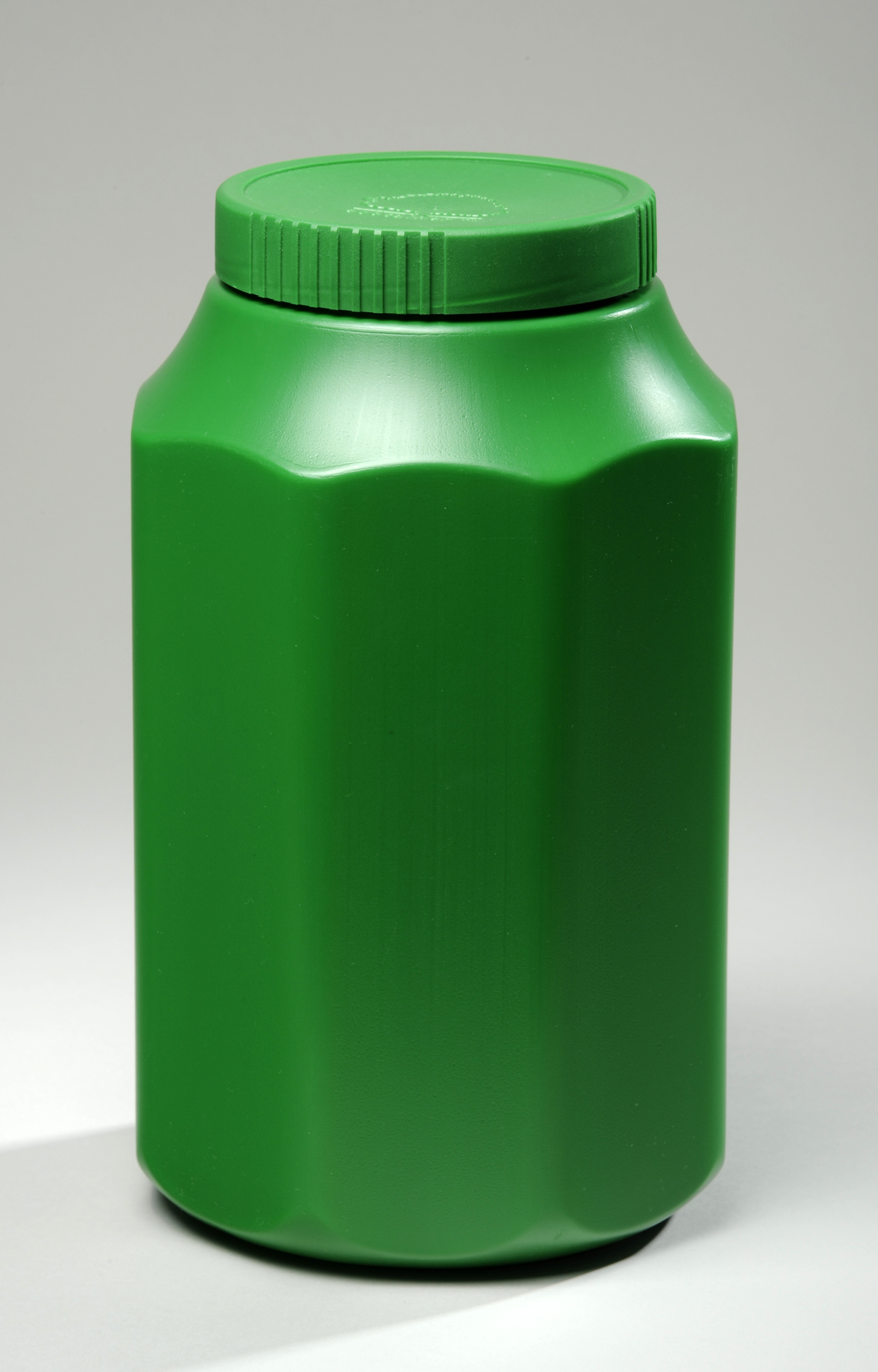 A bright green plastic urn with a screw-on lid. The urn stands straight up like a bottle, and has an octagonal horizontal cross section.