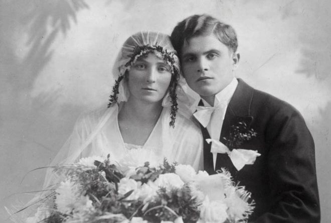 Young Polish couple's wedding portrait, 1929.  She holds a big bunch of flower..