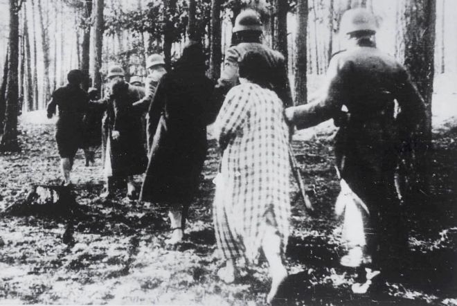 German soldiers leading women and children into a forest to be shot