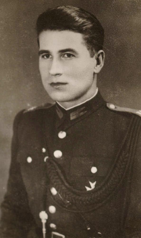 Stanislaw wears a police uniform and looks very smart.  His hair is swept back.