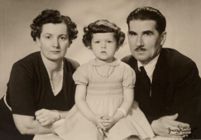 Black and white image with Lola on the left, Stansilaw on the right and their young toddler daughter, Barbara in the centre