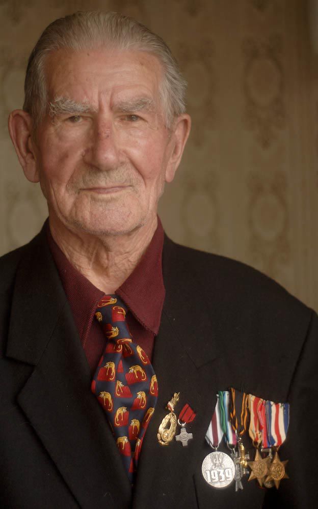 Elderly Polish man Stanislaw wearing his war medals in 2009
