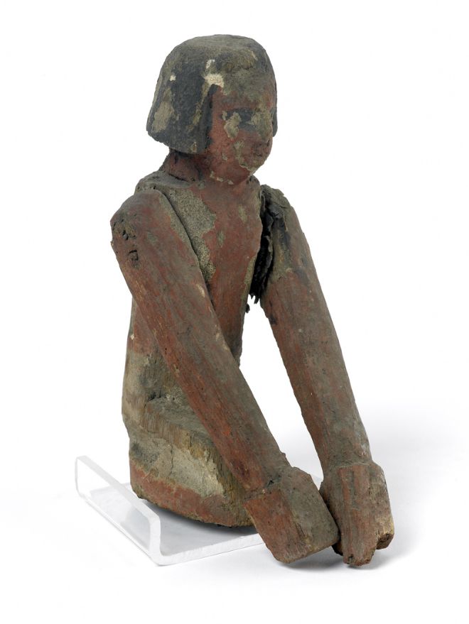 Close up of one of the wooden oarsmen.  Looking closely, you can still see the painted features on his face and he has black hair cut just below the ears in length.