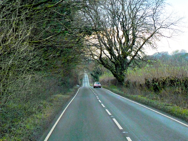 Colour photograph showing a modern road following a straight line through the British countryside