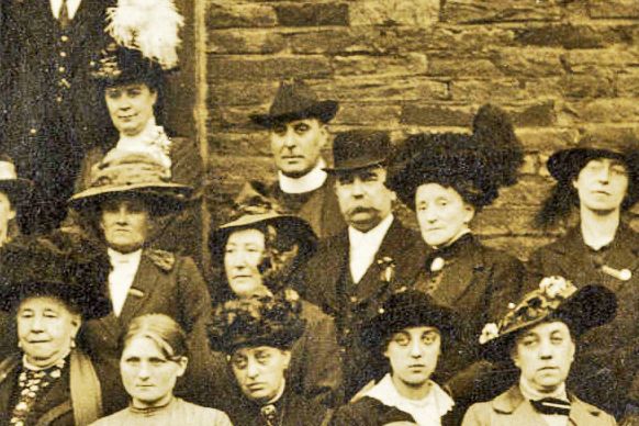 Close-up of refugees from the main photograph, showing the men and women at the back of the group