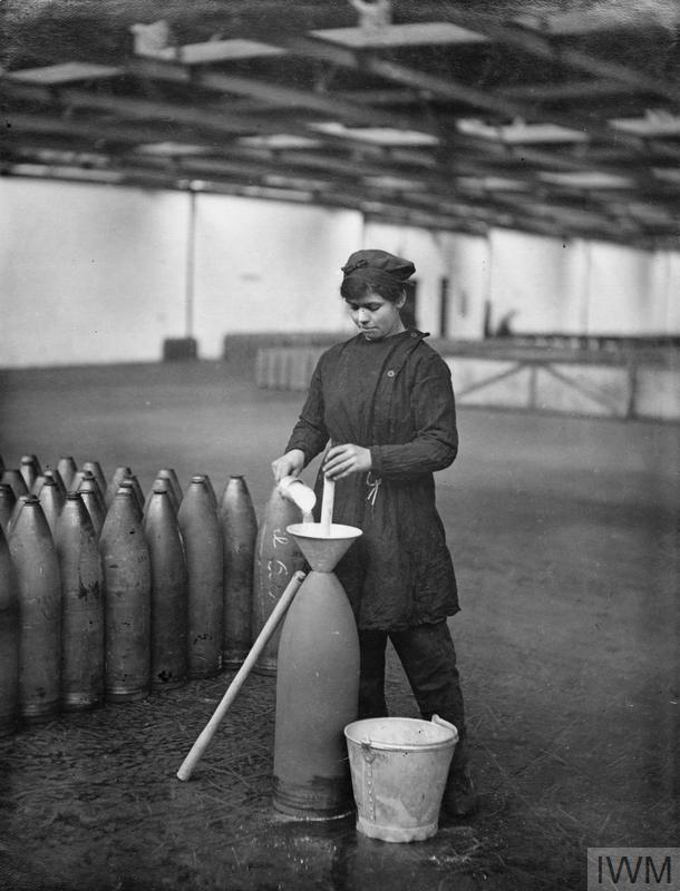 Female operator pouring AMT into a funnel ready for preliminary hand stemming, No. 14 National Filling Factory, Hereford