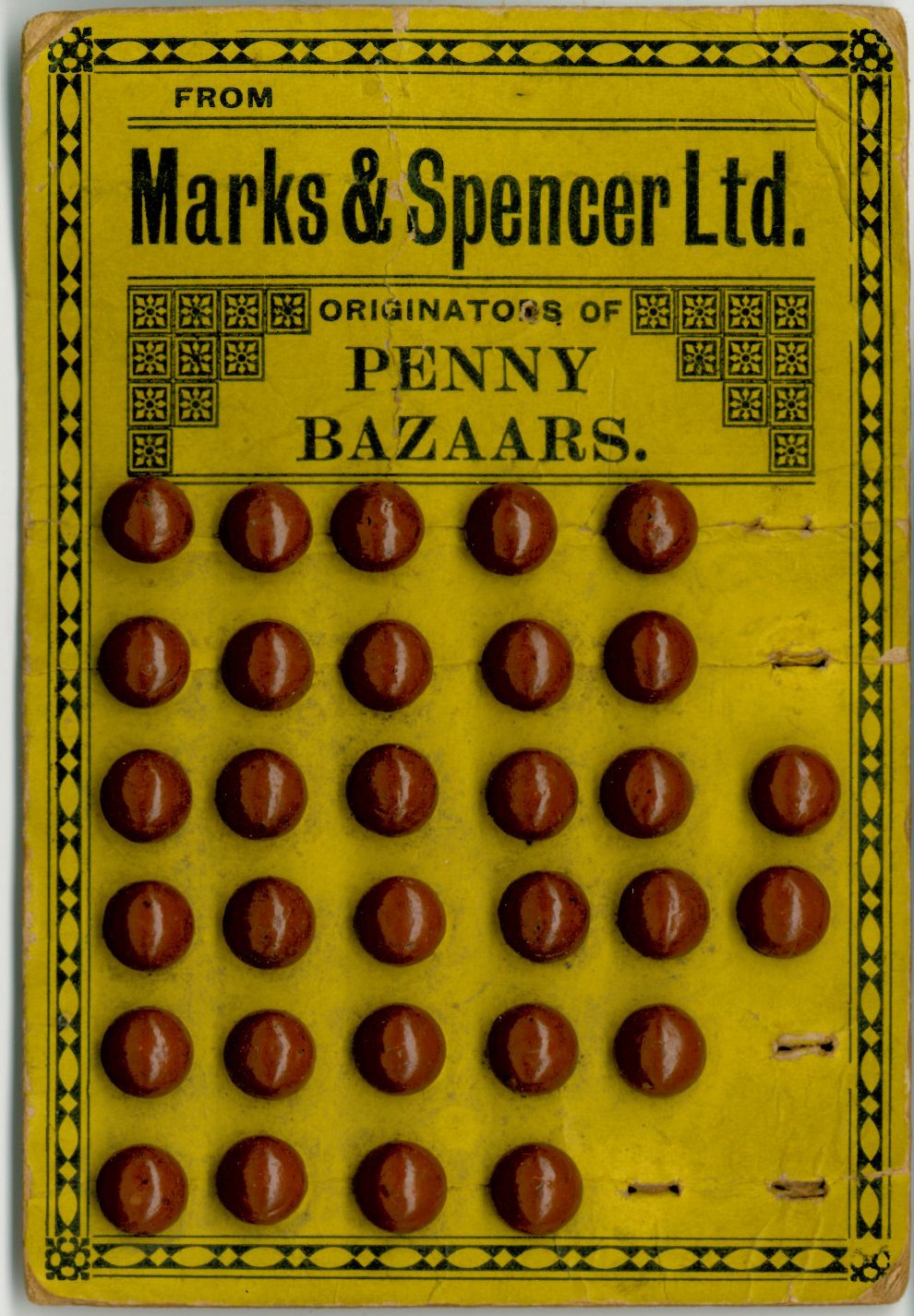 Yellow card of brown buttons with Marks and Spender branding