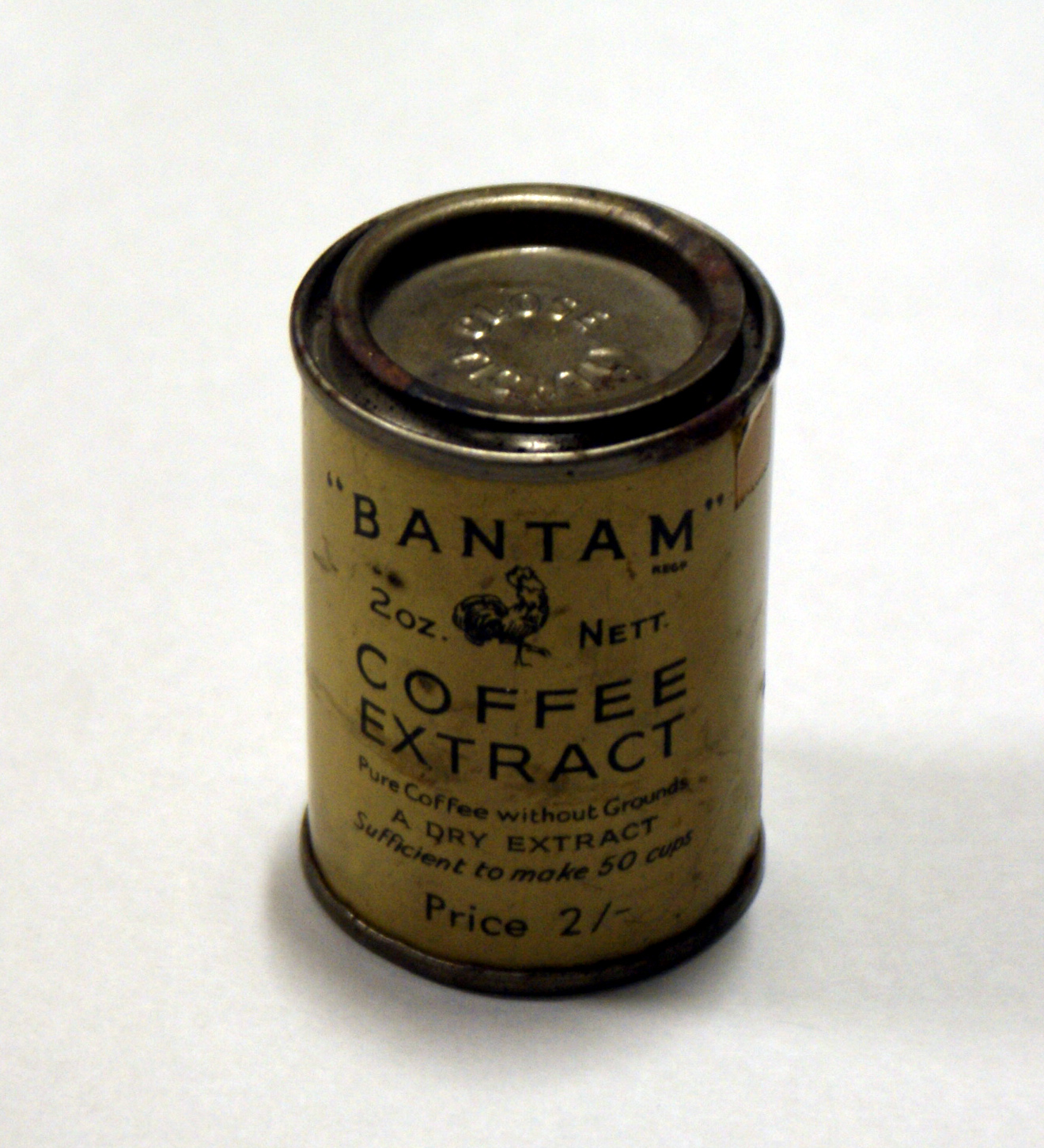 Colour photograph of a tin of coffee extract with a yellow and red label