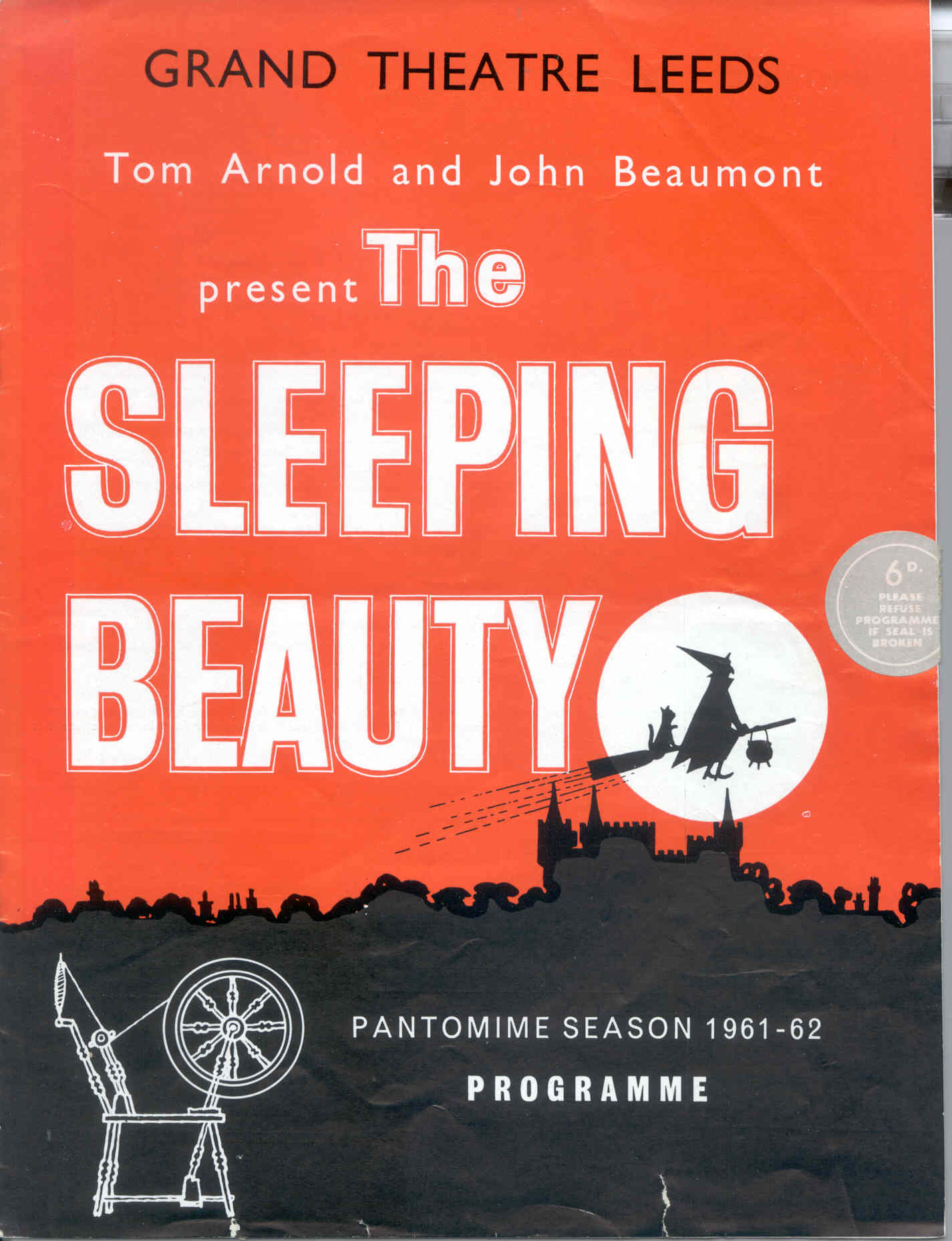 Poster showing the silhouette of a town with a full moon and a witch on a broomstick with a cat.