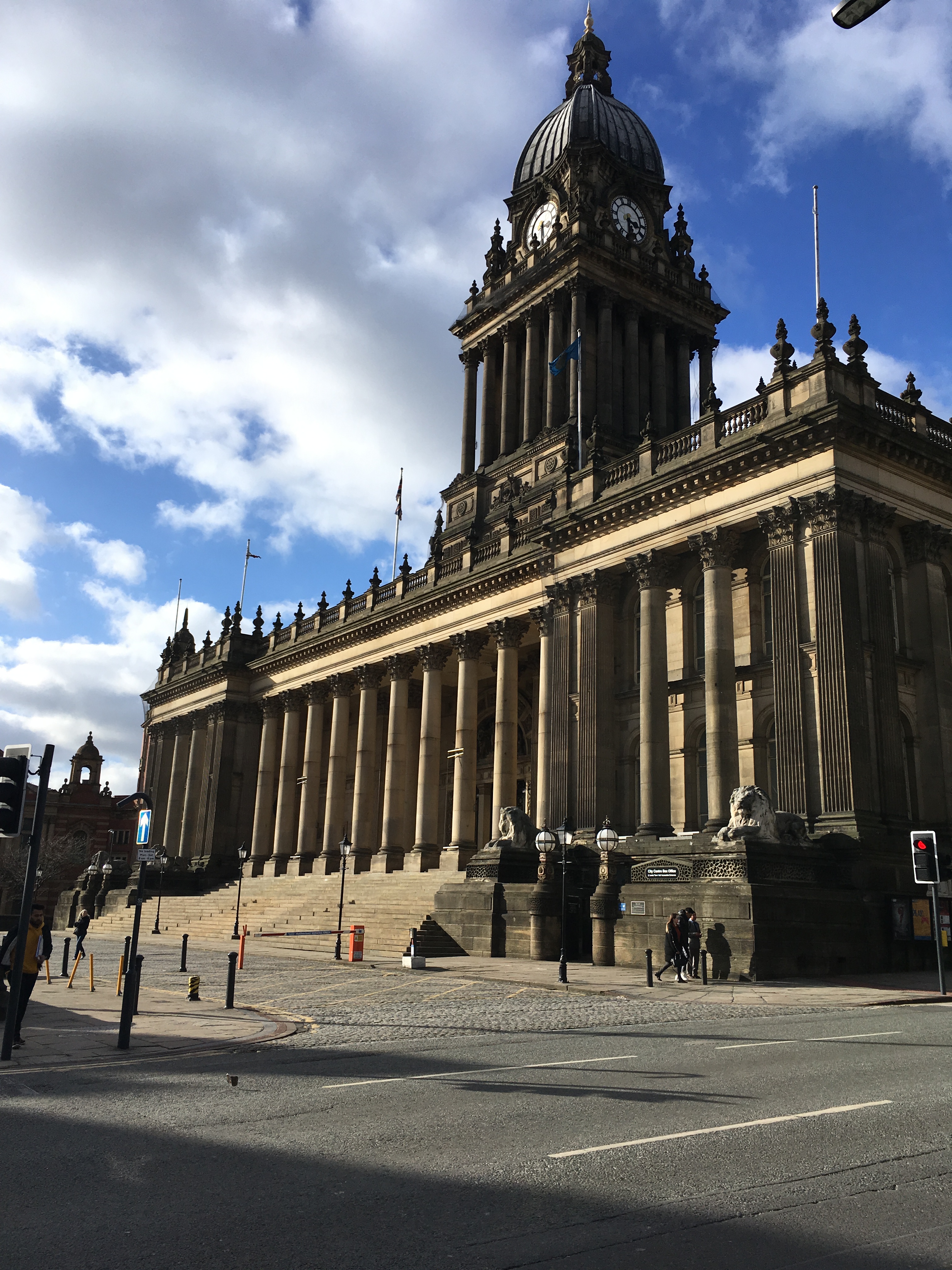 Colour photograph showing Leeds Town Hall with a large road running down the side of it.