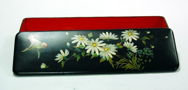 Black japanned narrow box with flowers and a bird painted on the lid.  The inside is painted a deep red.