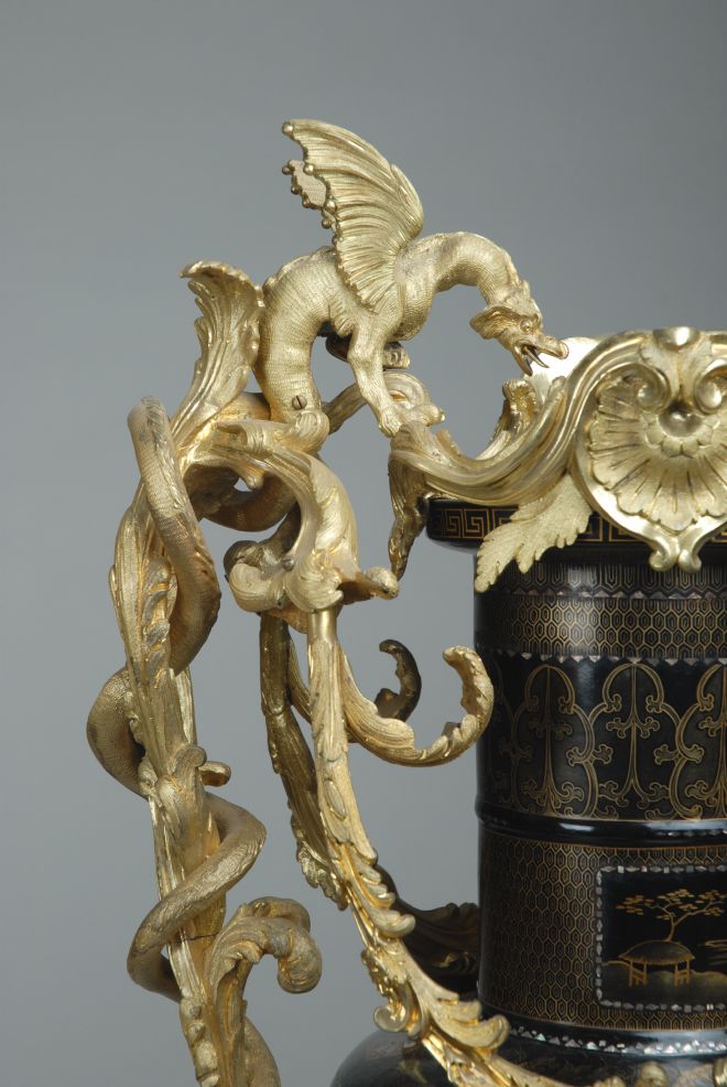 Close up of the gold handles designed as leafy vines and winged beasts.