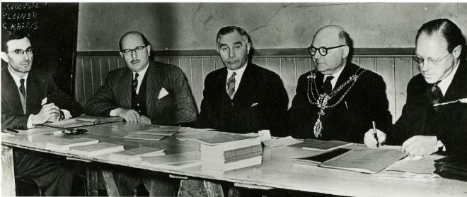 Photograph showing men from Hull Board of Guardians sitting around a table, having a meeting