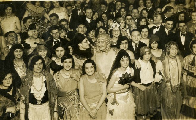 Black and white photograph showing Jewish men and women in fancy dress.