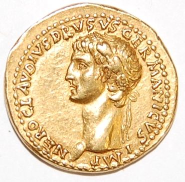 A gold Roman Coin, Showing the Head of a Young Caesar with an inscription around the outside