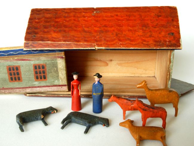 Made of wood, this set features simply carved wooden animals, a flat bottomed ark and two figures.