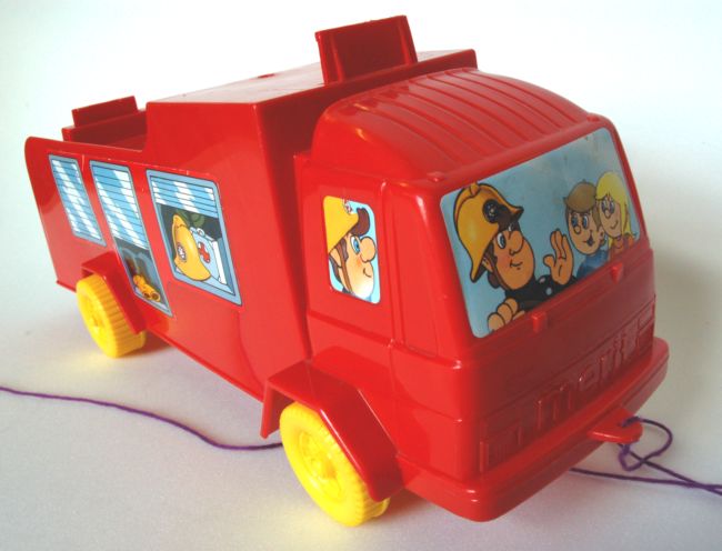 Pull-along fire engine dating from 1980s.  Stickers on the front and side show illustrations of two firemen and two children.  The truck is red with yellow wheels.