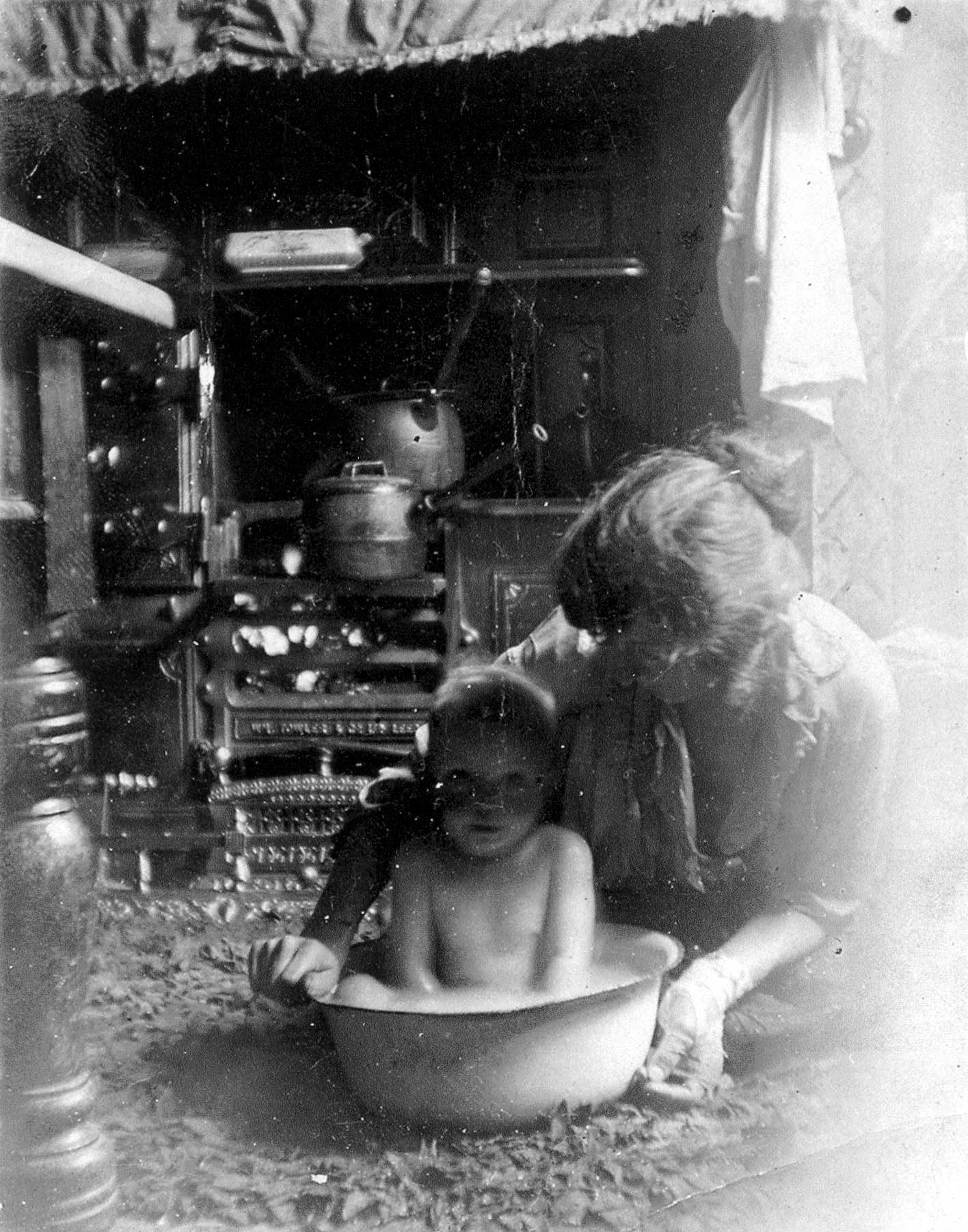 Photograph of Child Being Bathed in a Tub
