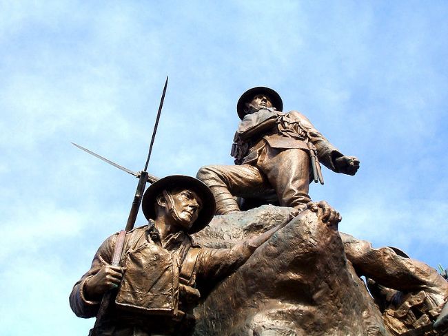 Close up photograph of Oldham war memorial showing two WW1 soldiers wearing helmets and holding bayonets