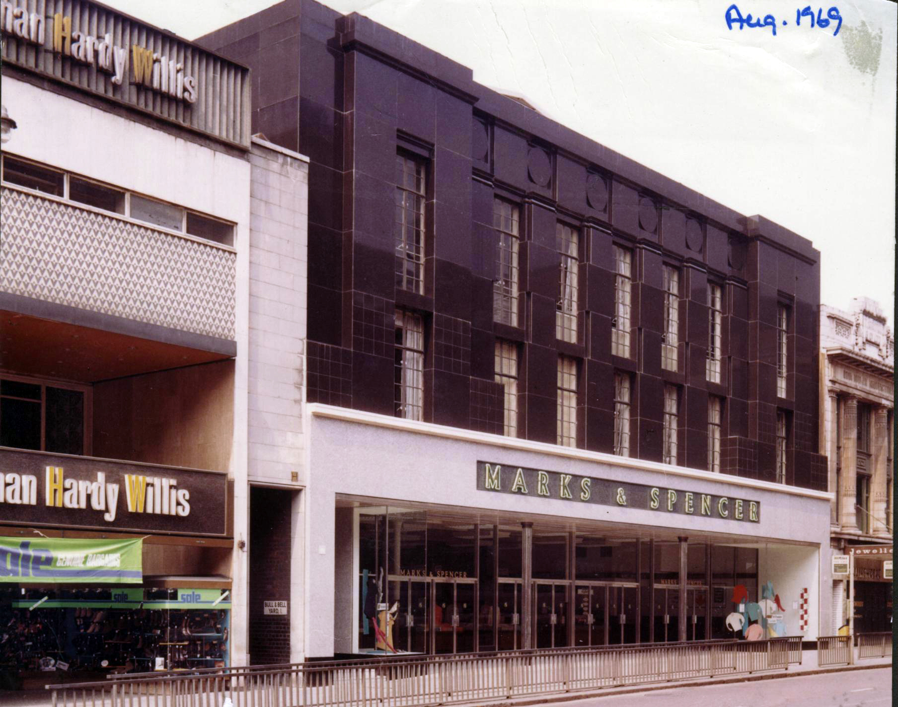 Marks & Spencer store exterior dated August 1969, shown between neighbouring shops.