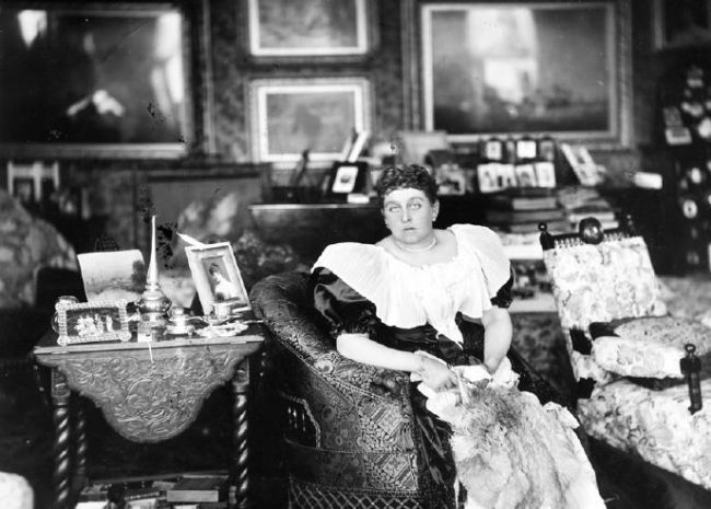 Photograph taken in the 1870s of the interior of the drawing room at Singleton Hall, Preston, showing expensive furniture and objects.