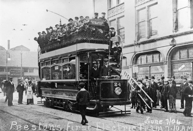 Open top electric tram in Preston packed with people on the open top