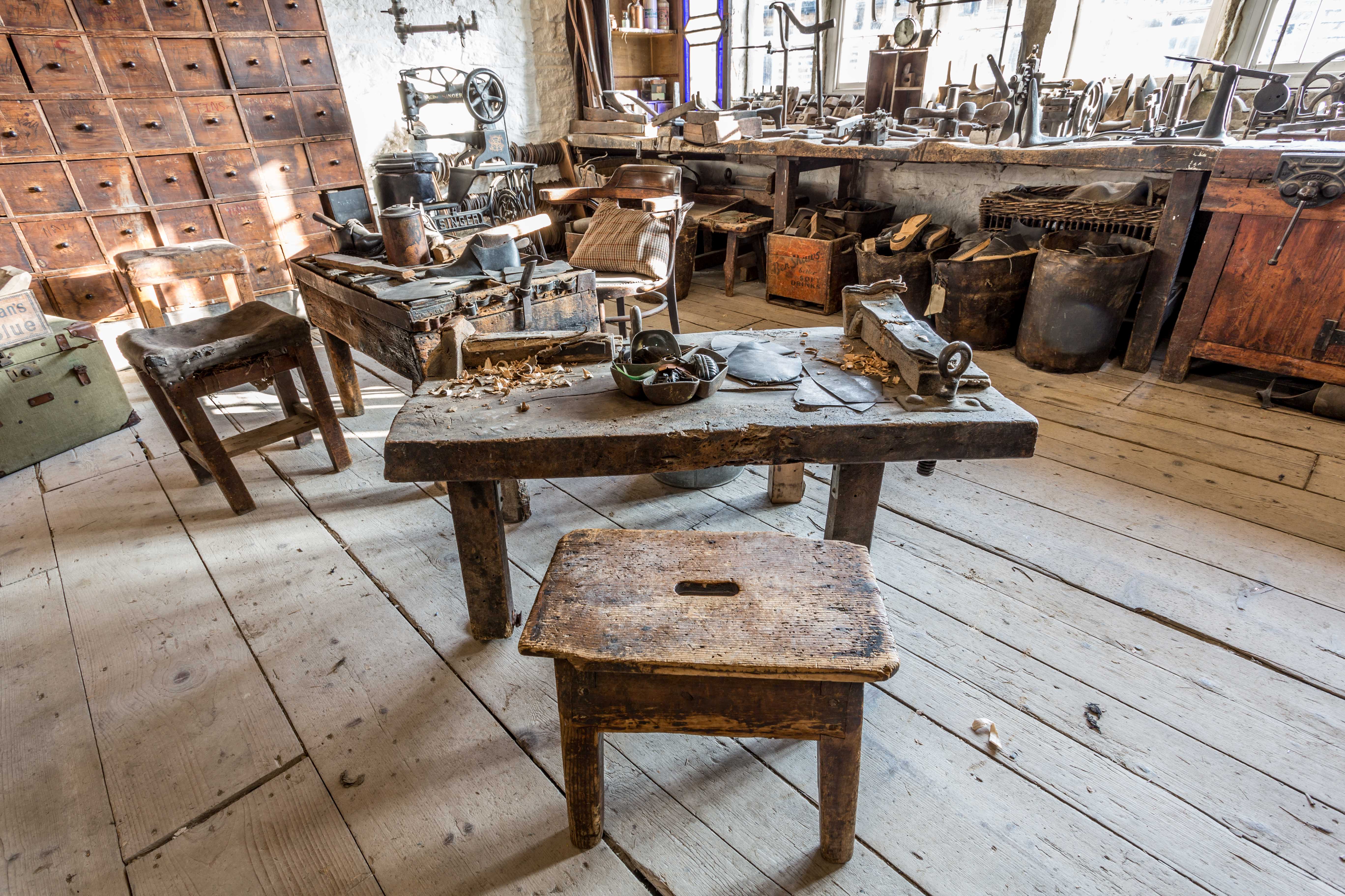 Colour photograph showing a clogmakers bench, with the tool used to carve the wooden soles.
