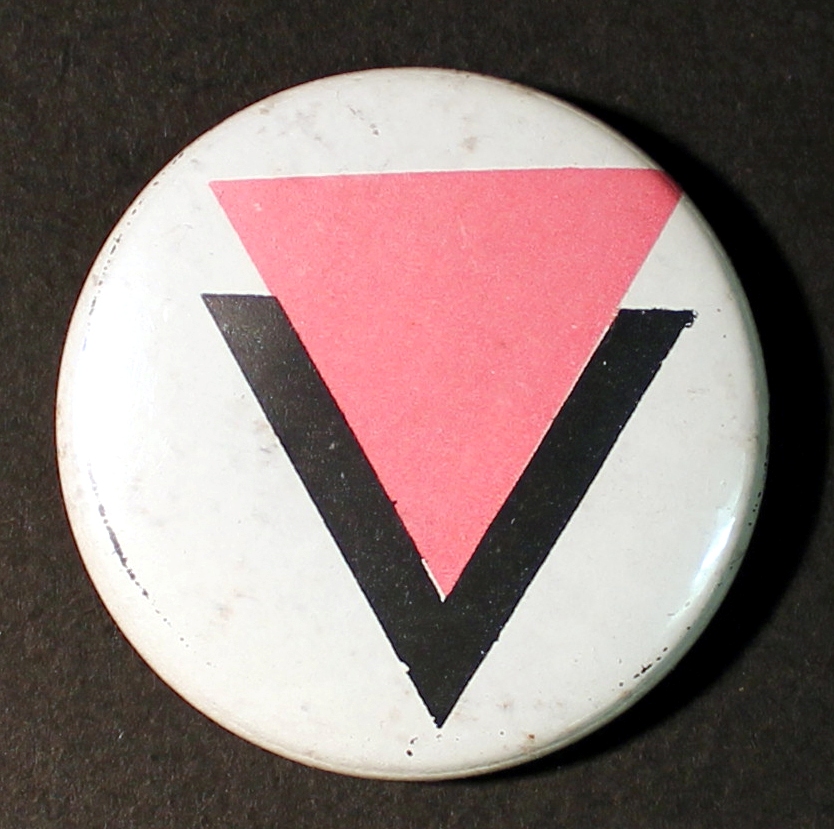 Intentional Promotions pin badge with pink and black triangles
