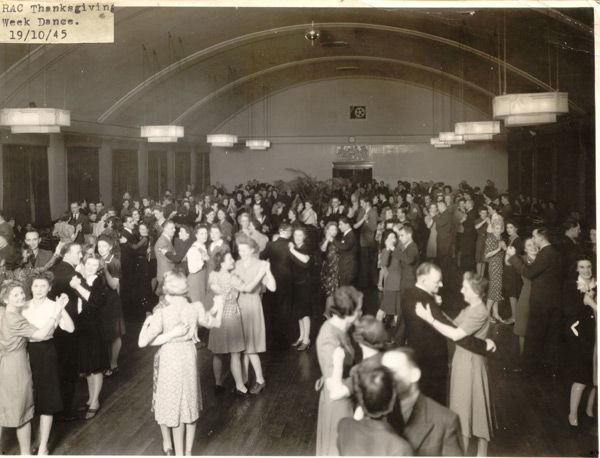 Black and white photograph showing couples dancing in a big hall.  There are a few men, but mostly women.