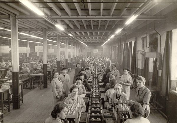 Black and white photograph of women working on a production line in a factory