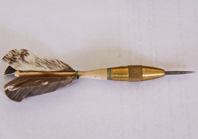Brass dart with feathered flight