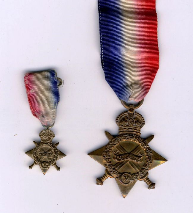 Private Edmund McKee's First World War medals with replica 1914-15 Star.  Ribbon have vertical red, white and blue stripes.  On the left is a smaller version  used to dress.
