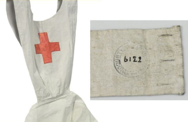 White apron with red cross on the front