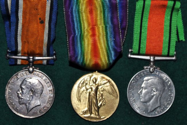 Three medals, two silver coloured, one gold coloured.