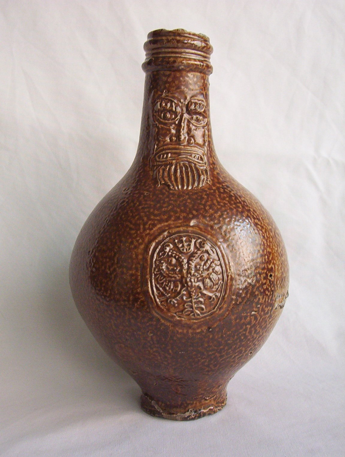 Brown earthenware Bellarmine jug from time of Civil War